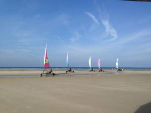 a group of people on the beach with sailboats at Studio, sea side in Berck-sur-Mer