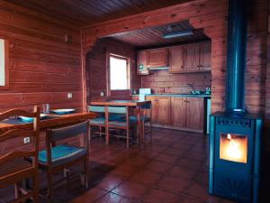 a kitchen with a wood stove in a cabin at Chalé do Zêzere in Cortes do Meio