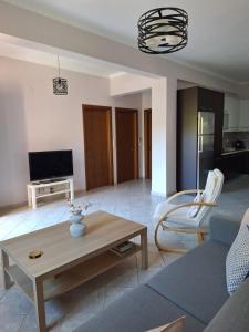 a living room with a couch and a coffee table at B&B one in Vonitsa