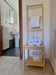 a bathroom with a sink and a shelf with towels at B&B one in Vonitsa +46 photos