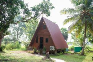 a small wooden house with a red roof at Gimanhala Thisawewa in Anuradhapura