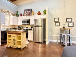 a kitchen with white cabinets and a stainless steel refrigerator at Haven at Hazel - the Residence in Demorest