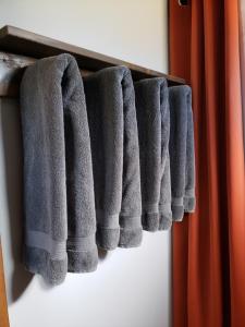 a row of gray towels hanging on a shelf at Private, Charming Cabin - Sleeps 5 - The Evergreen - Bryce Canyon National Park in Cannonville