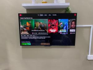a flat screen tv hanging on a wall at Homestay Teratak Nailufar in Pekan
