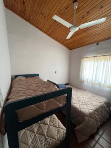 a bedroom with a bed and a ceiling fan at Casa Paso in Paso de la Patria