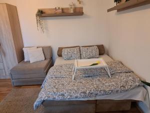 a room with a bed with a table on it at Apartaman Sweet Home in Bačka Palanka