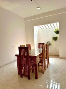 a dining room with a wooden table and chairs at The horezt in Kamburugamuwa