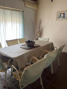 a table with chairs and a bowl of grapes on it at Casa Paso in Paso de la Patria