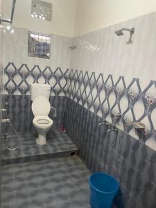 a bathroom with a toilet and a shower at Care Guest House in Bhubaneshwar