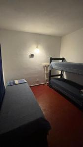 a room with two bunk beds and a table at Casa La micelia in Pinamar
