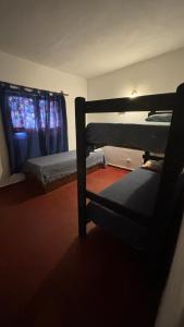 a bedroom with two bunk beds and a window at Casa La micelia in Pinamar