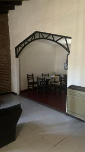 a dining room with chairs and a table in a room at Casa La micelia in Pinamar