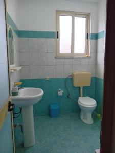 a bathroom with a sink and a toilet at The quiet house in Durrës