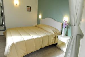 En eller flere senge i et værelse på Residence Les Amis