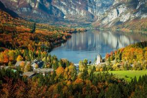 a small town on a lake in the mountains at Bled Castle View Apartment Medina in Zgornje Gorje