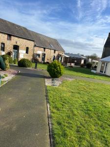 a house with a walkway in front of a yard at Mobil Home Litteau Calvados in Litteau