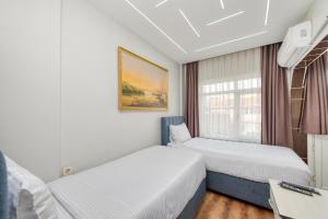 a hotel room with two beds and a window at Bright Apart Hotel in Istanbul