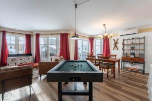 a living room with a pool table in it at Condo Lac Archambault Fireplace beach in Saint-Donat-de-Montcalm