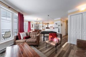 a living room with a couch and chairs and a table at Condo Lac Archambault Fireplace beach in Saint-Donat-de-Montcalm