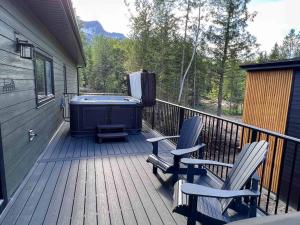 a deck with two chairs and a hot tub at Powder House Chalet by Fernie Central Reservations in Fernie +46 photos