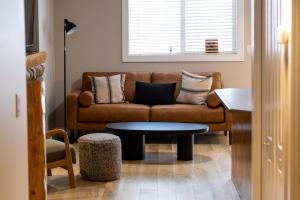 a living room with a couch and a table at Riverside Condos by Fernie Central Reservations in Fernie +15 photos