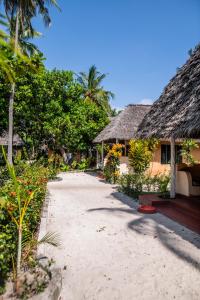a resort with a sandy beach and trees and a building at Afro Beach Safari in Kilindoni