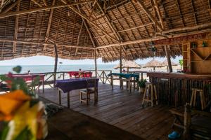 a restaurant on the beach with tables and chairs at Afro Beach Safari in Kilindoni +38 photos