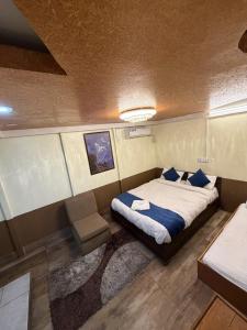 a bedroom with a bed and a chair in it at Hotel Sakura & Tandoori Restaurant in Kathmandu