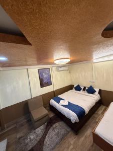 a bedroom with a bed with blue pillows at Hotel Sakura & Tandoori Restaurant in Kathmandu +3 photos