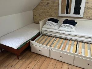 two beds sitting next to each other in a room at Charming Heritage Townhouse in Odense