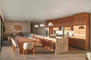 a kitchen and dining room with a table and chairs at Pool - Spa - Fire pit - Views - BBQ - Bella Nova in Joshua Tree