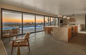 a kitchen and dining room with a view of a pool at Pool - Spa - Fire pit - Views - BBQ - Bella Nova in Joshua Tree +47 photos