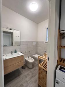 a bathroom with a sink and a toilet and a tub at Casa Aniste in Castelsardo +29 photos