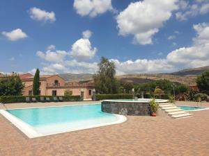 a swimming pool in a yard with a house at Agriturismo Tenute Spartà in Randazzo