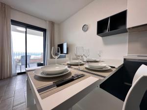 a kitchen with a table with plates and wine glasses at Casa Aniste in Castelsardo