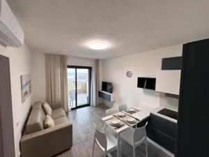 a living room with a couch and a table and chairs at Casa Aniste in Castelsardo