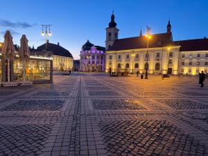 an empty plaza in a city at night at Vista Rustic Room in Sibiu