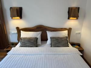 a bedroom with a bed with two pillows at Vista Rustic Room in Sibiu +16 photos