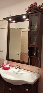 a bathroom with a sink and a mirror at Orlando House 1975 in Montecchio