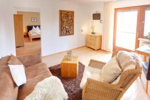 a living room with a couch and a table at Haus Schmölz Ferienwohnung Allgäu in Hopferau