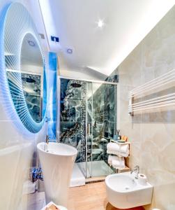 a bathroom with a sink and a toilet and a shower at El Patio Hotel in Corciano