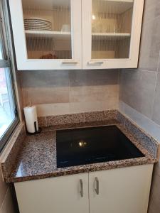 a kitchen counter with a sink in a room at Atico Marin playa in Marín +22 photos