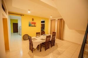 a dining room with a white table and chairs at Airport Serenity Villa - Near Colombo Airport in Katunayaka