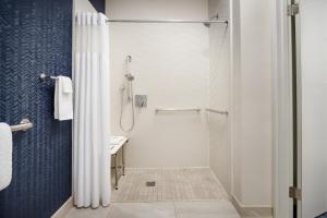 a shower with a glass door in a bathroom at Fairfield Inn by Marriott Scranton in Scranton