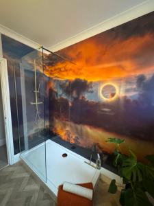 a bathroom with a shower with a painting on the wall at Half Moon Nest - Refurbished throughout for 2026 in Diss