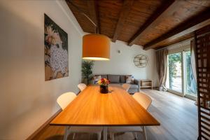 a dining room with a wooden table and chairs at Urban Nest in Forlì