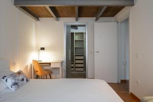 a bedroom with a bed and a desk and a chair at Urban Nest in Forlì