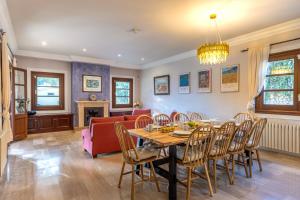 a dining room and living room with a table and chairs at Villa Nobleza, oasis con piscina y gimnasio a 2 min del centro in El Port de la Selva +63 photos