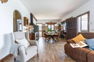 a living room with a couch and a table at Villa for 4 with feature pool & great reviews in Bédar