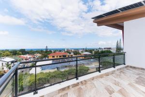 a balcony with a view of a city at PF Hotel in San Felipe de Puerto Plata
